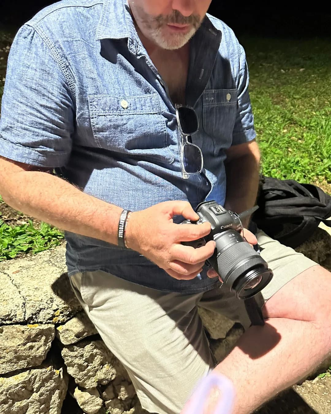 Photographer checking a Canon camera on location