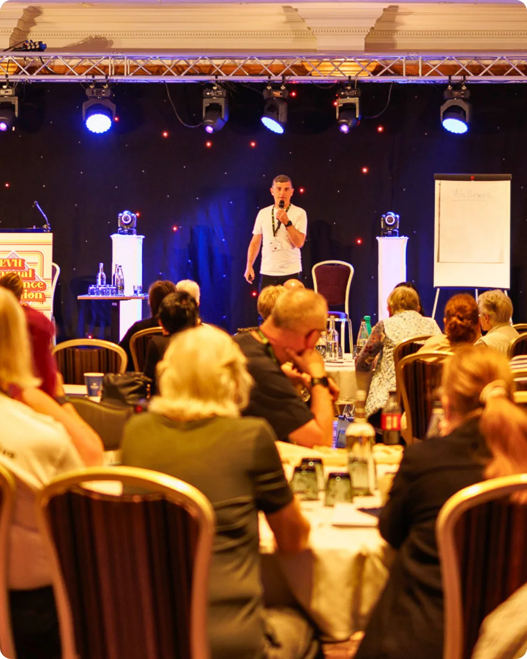 Conference speaker photographed at a live event