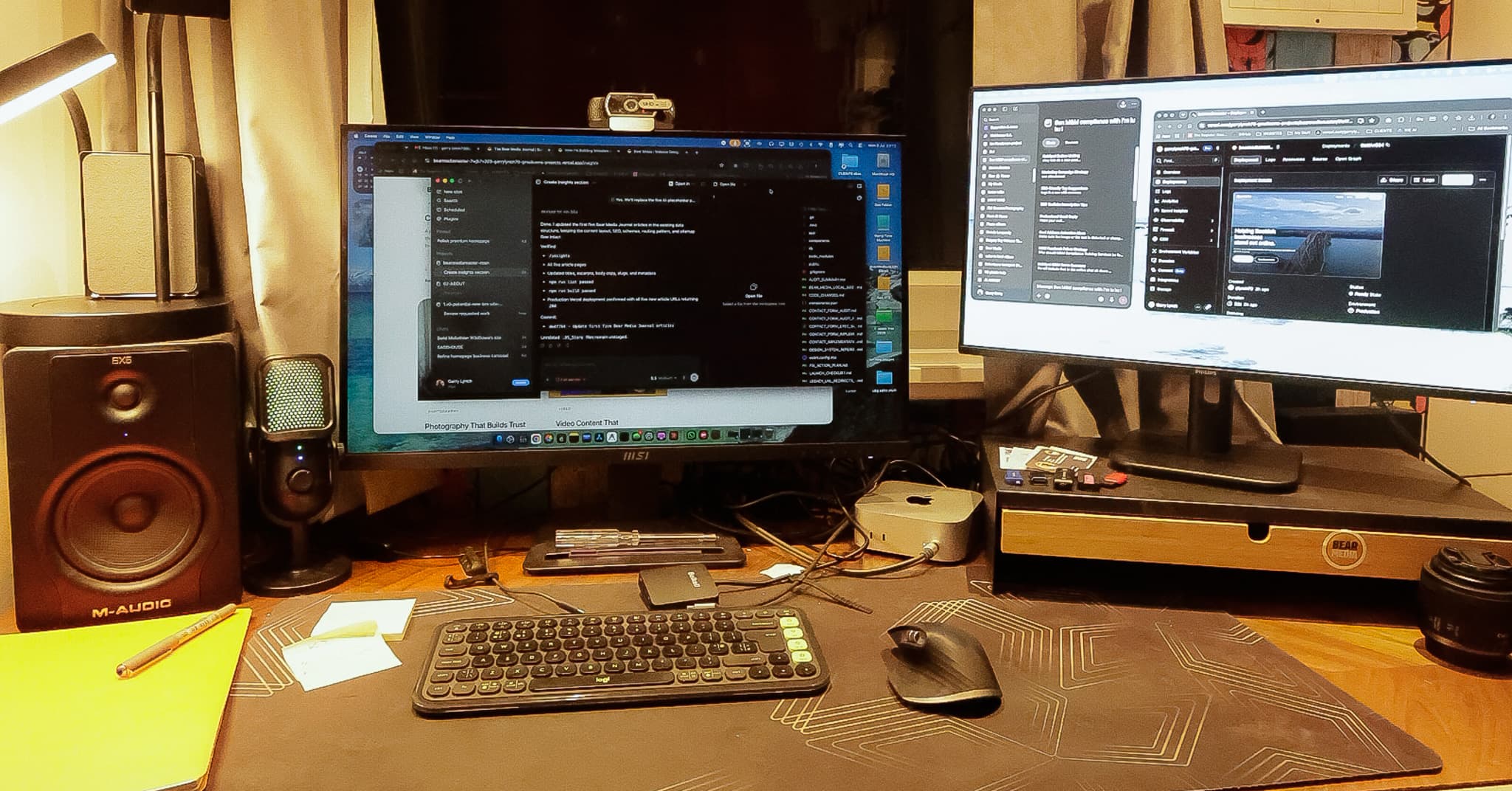 Bear Media workspace with monitors, microphone, keyboard and desk tools